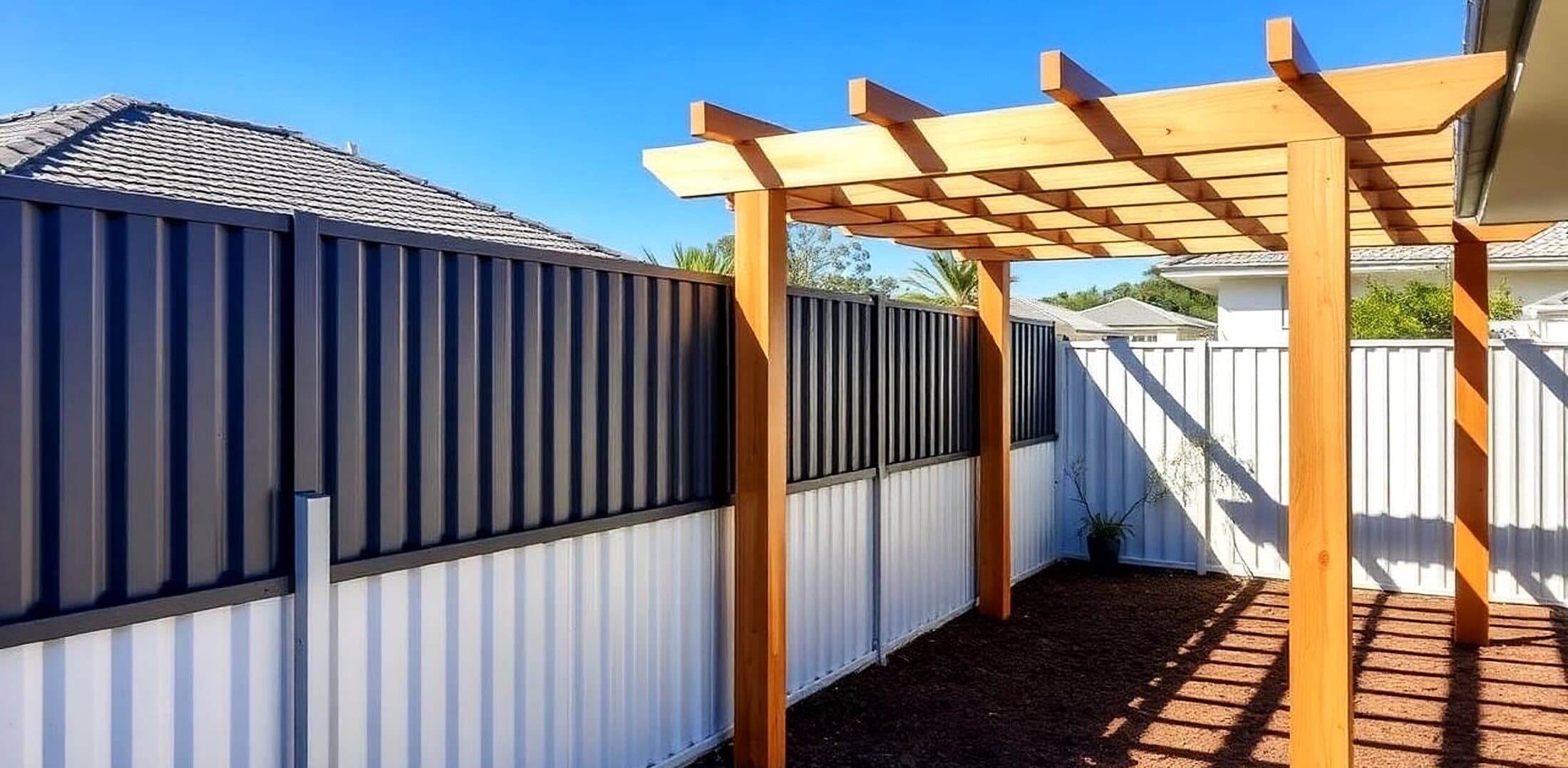 Timber pergola and new Colorbond fencing in a backyard